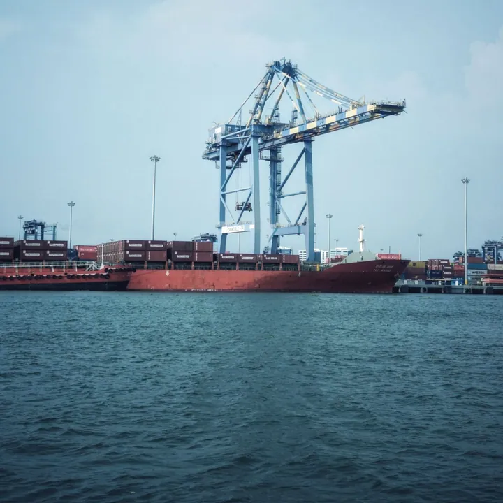 Cargo ship and container crane at an industrial port.